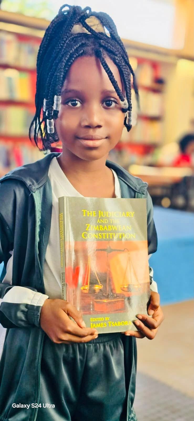 Pupil holding The Judiciary and the Zimbabwean Constitution