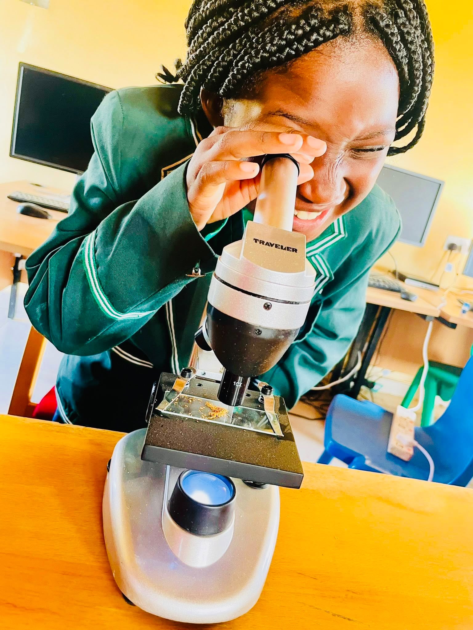 Pupil looking through a microscope