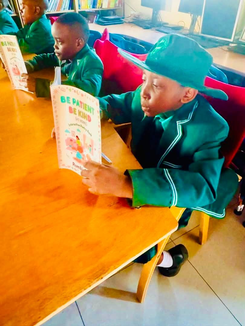 Pupils reading poetry books in the library