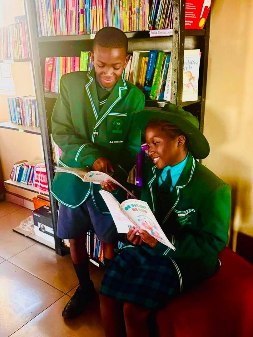Two pupils reading together