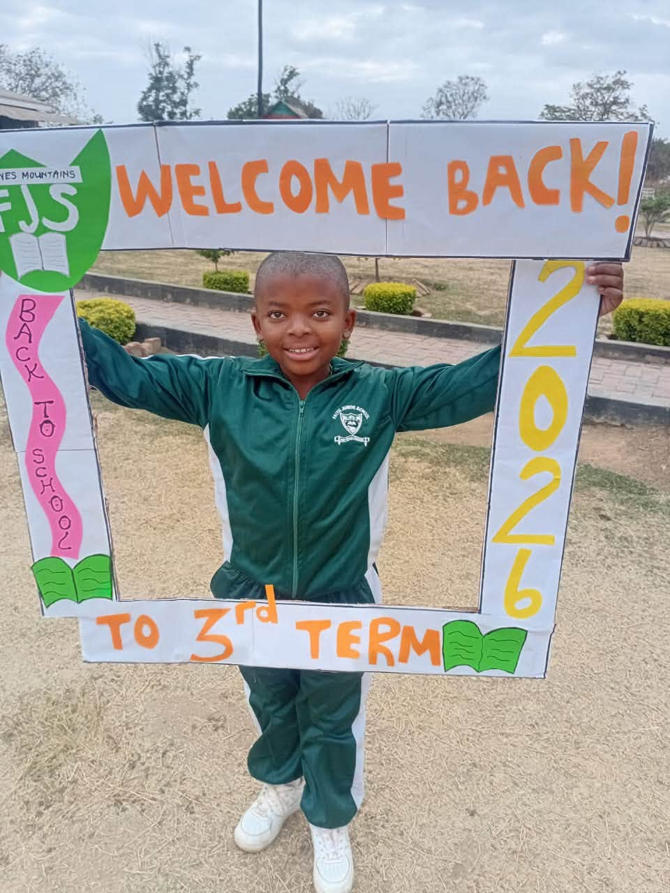 Pupil holding a Welcome Back to 3rd Term 2026 frame