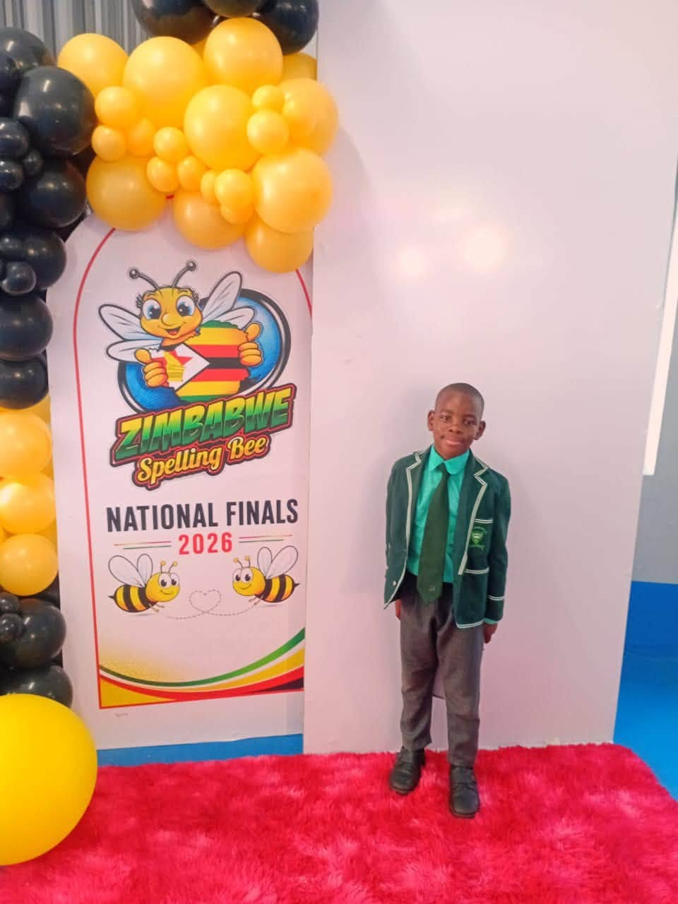 Hugh in front of the National Finals 2026 banner